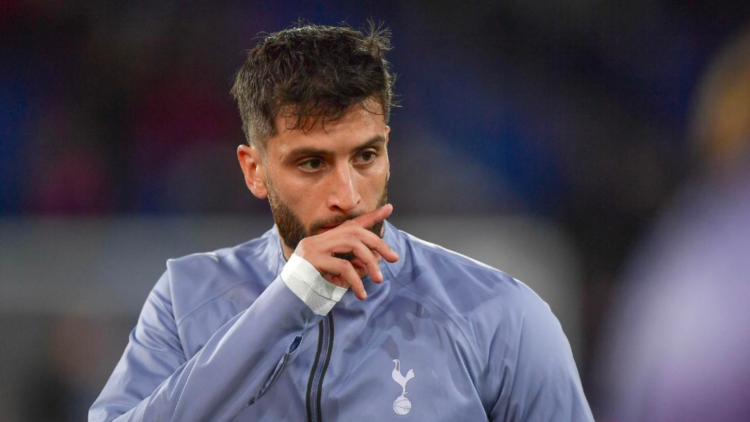 Tottenham midfielder Rodrigo Bentancur scratches his face before a game.