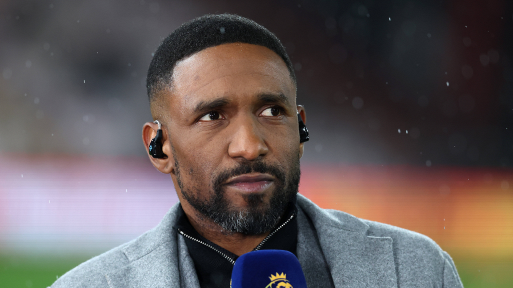 Former Tottenham striker Jermain Defoe glances to his right while working as a pundit.