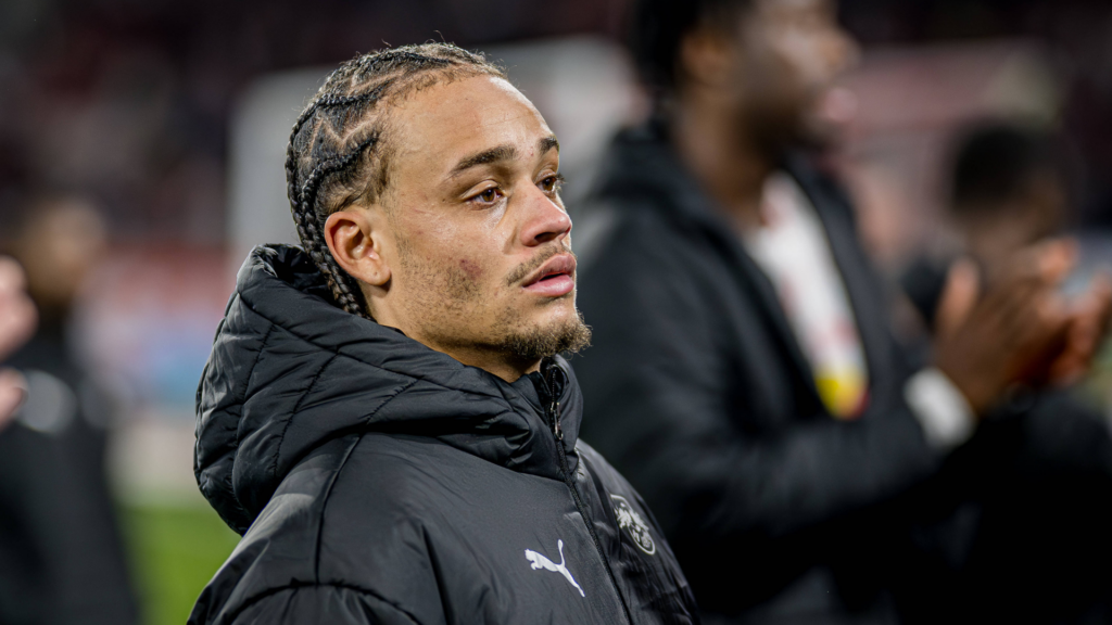 Tottenham star Xavi Simons stares into the distance while wearing a