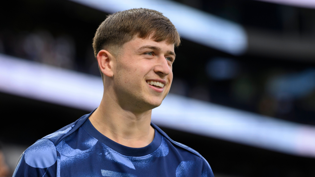 Tottenham starlet Mikey Moore smiles while warming up before a game.