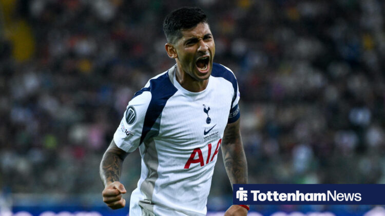 Cristian Romero celebrating in an all-white Tottenham strip