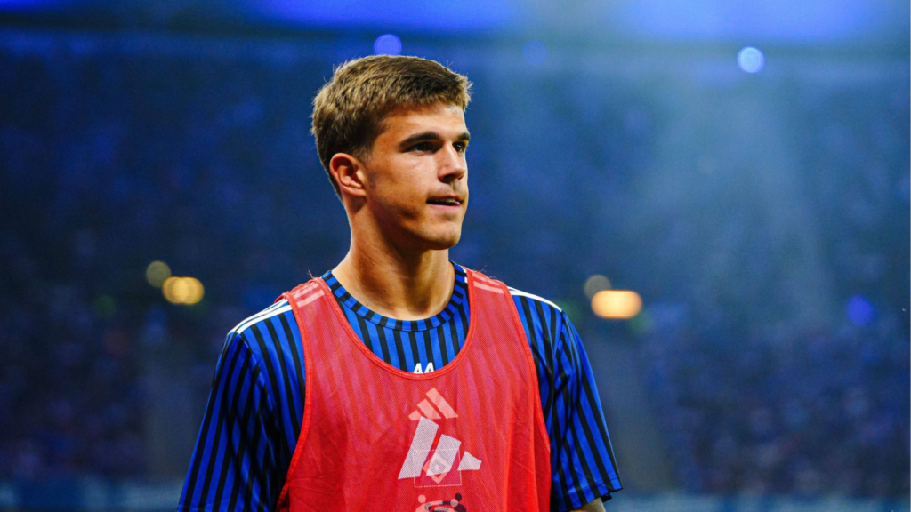 On loan Tottenham defender Luka Vuskovic stares into the distance while warming up on the touchline for Hamburg.
