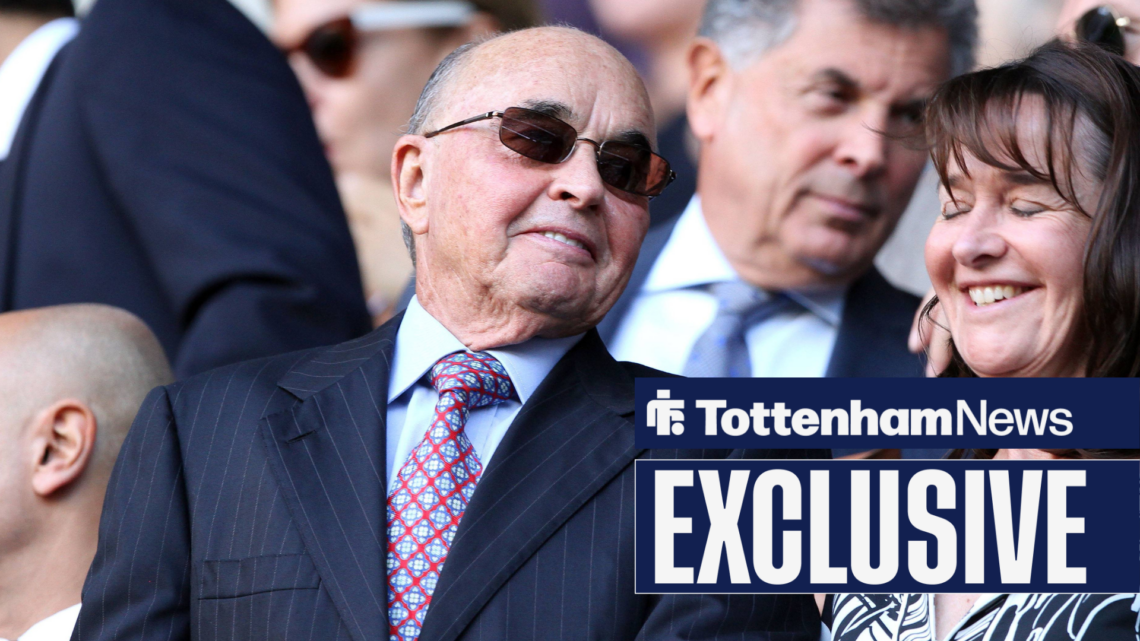Joe Lewis smiles while wearing a suit in the Tottenham stands.