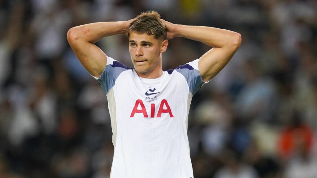 Micky Van de Ven holds his hands on his head.