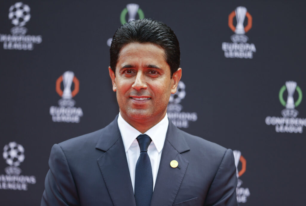 Nasser Al-Khelaifi smiles while wearing a suit.