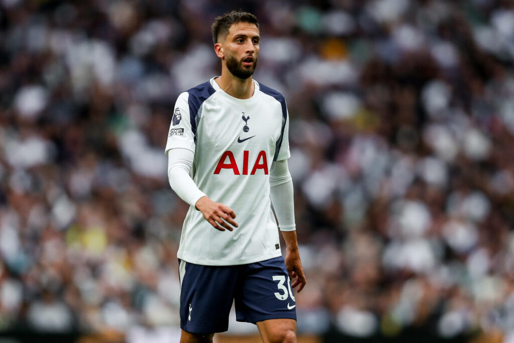 Rodrigo Bentancur strides in Tottenham home strip.