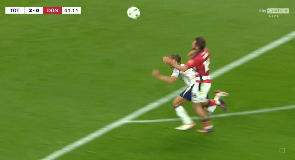 Xavi Simons goes down in a duel against Doncaster's Tom Nixon.