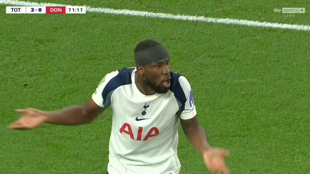 Kevin Danso looks shocked towards the referee.