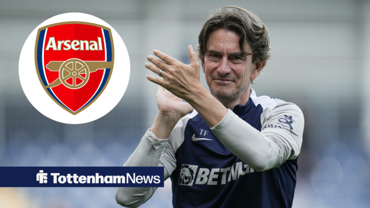 Tottenham manager Thomas Frank smiles and applauds in the direction of the Arsenal badge.