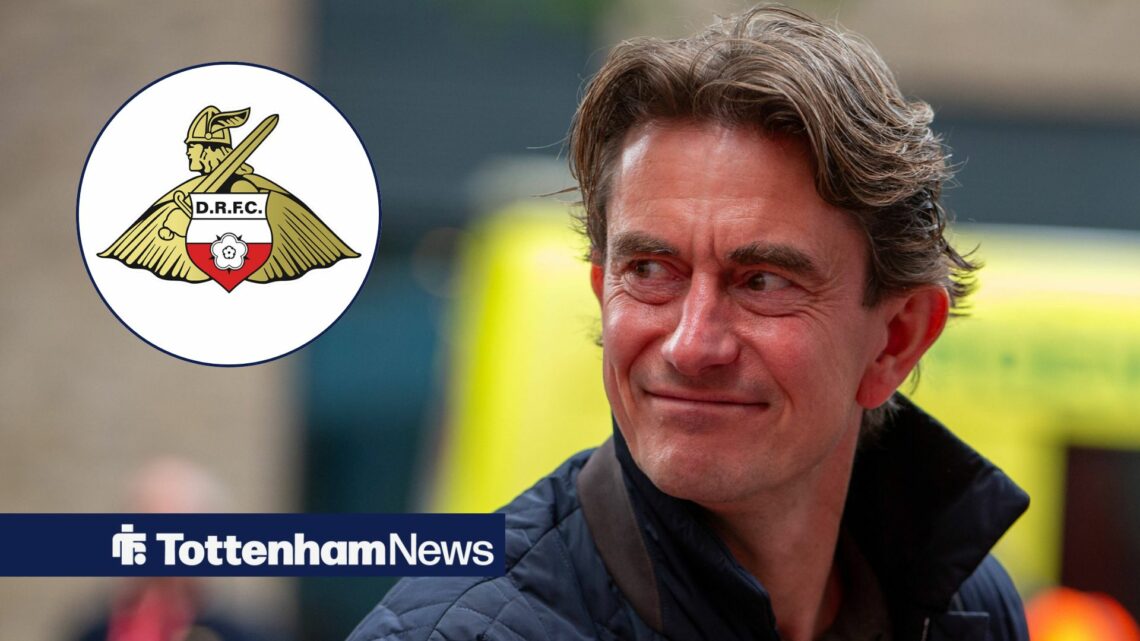 Tottenham manager Thomas Frank smiles towards the Doncaster Rovers badge, which features in a circular inset on the left of the image.