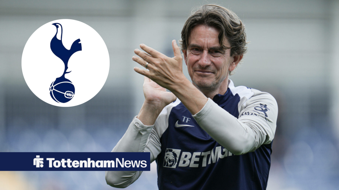 Tottenham manager Thomas Frank applauds in the direction of a circular inset that features the Tottenham badge.