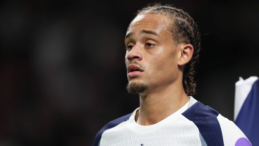 A close-up image of Xavi Simons as he stares into the distance during a game for Tottenham.