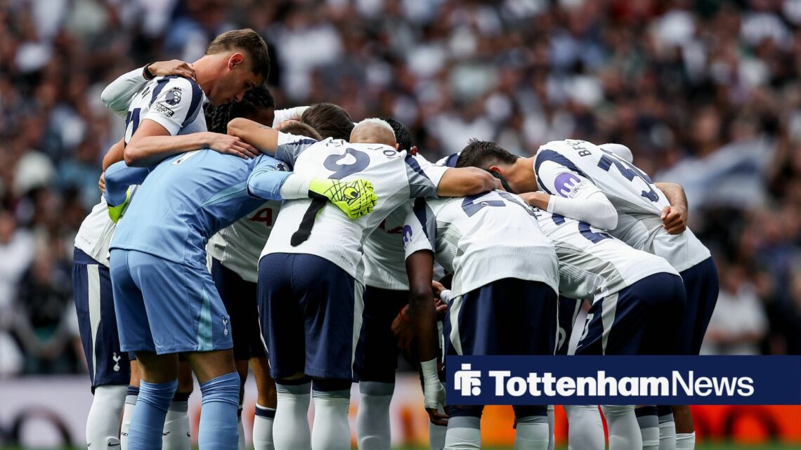 Tottenham's players huddle on the pitch