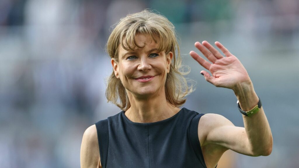 Prospective Tottenham investor Amanda Staveley smiles and waves.