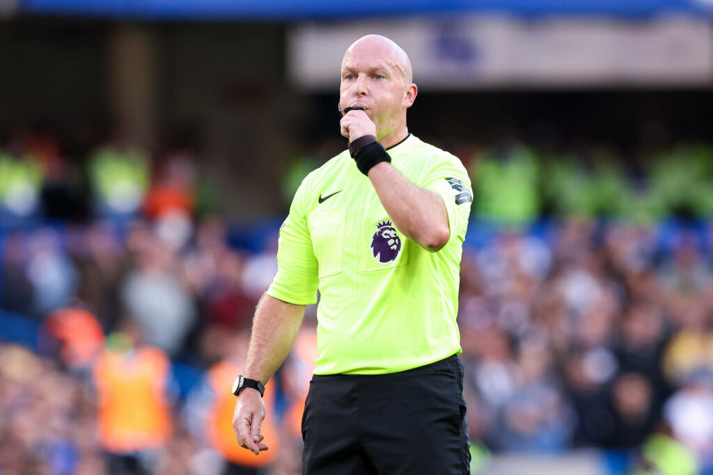 Premier League referee Simon Hooper blows his whistle