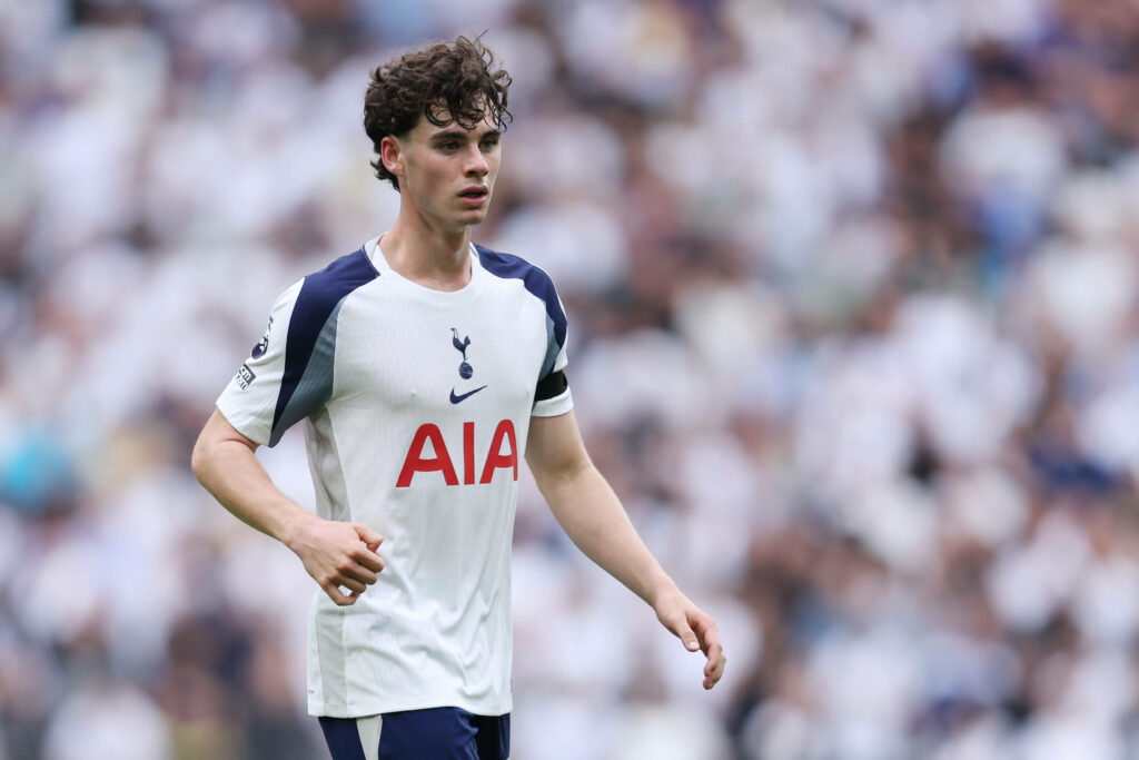 Archie Gray concentrates as he plays for Tottenham.