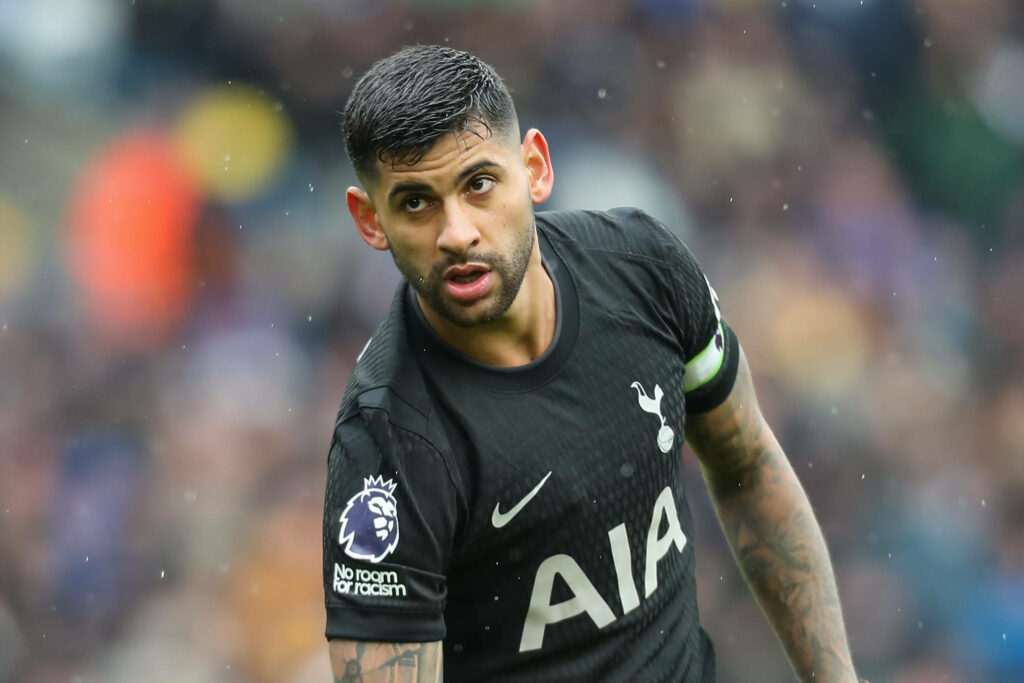 Cristian Romero in action for Tottenham in the rain