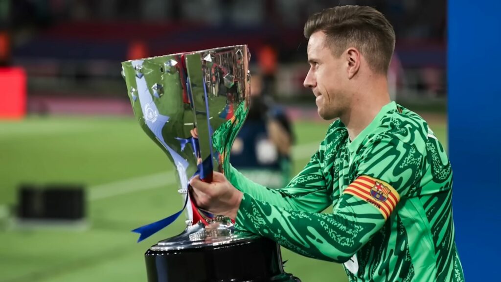 Marc-Andre ter Stegen celebrating by lifting a trophy with Barcelona