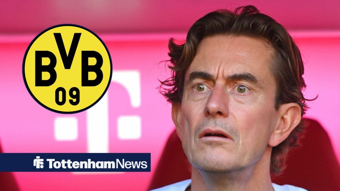 Thomas Frank stares at the Borussia Dortmund badge.