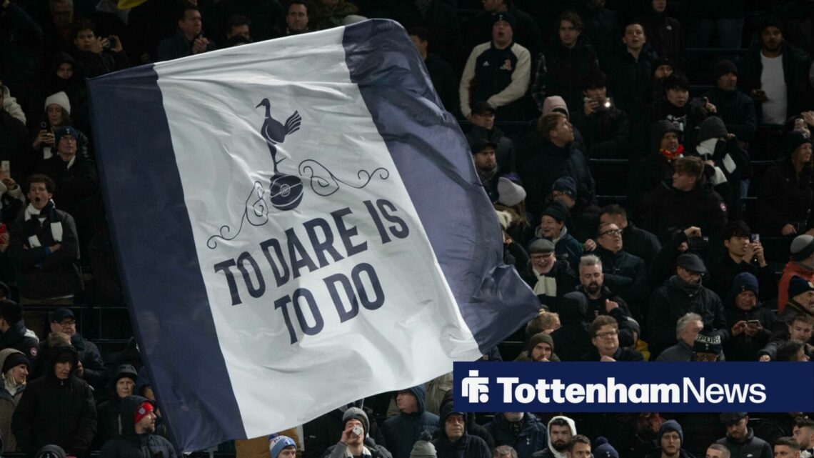 Tottenham Fans holding a 'To Dare Is To Do' flag.