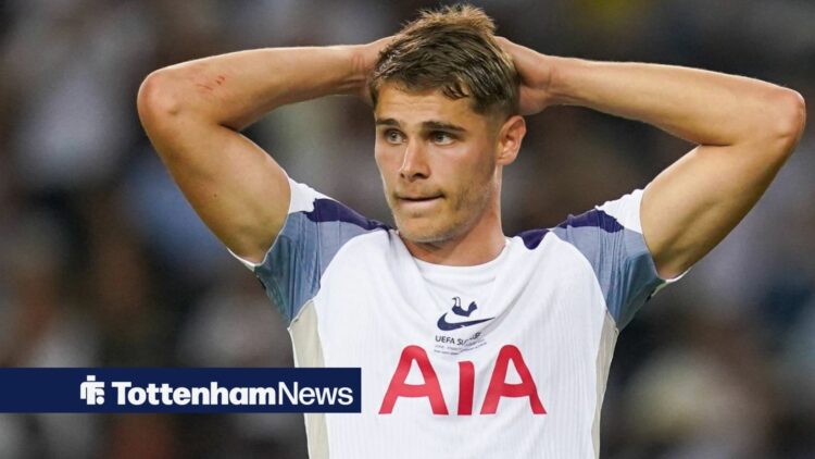 Tottenham defender Micky van de Ven stands with his hands on his head during a game.
