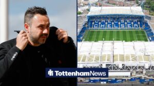 Roberto De Zerbi pulling his collar up, with a general shot of Stamford Bridge to his right